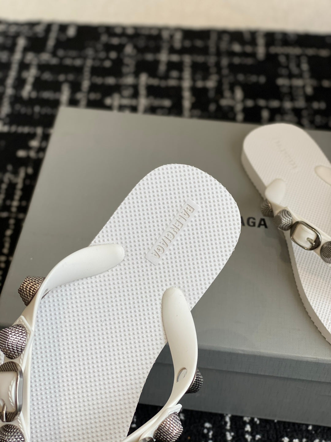 White thong sandal sole with embossed Balenciaga text near heel