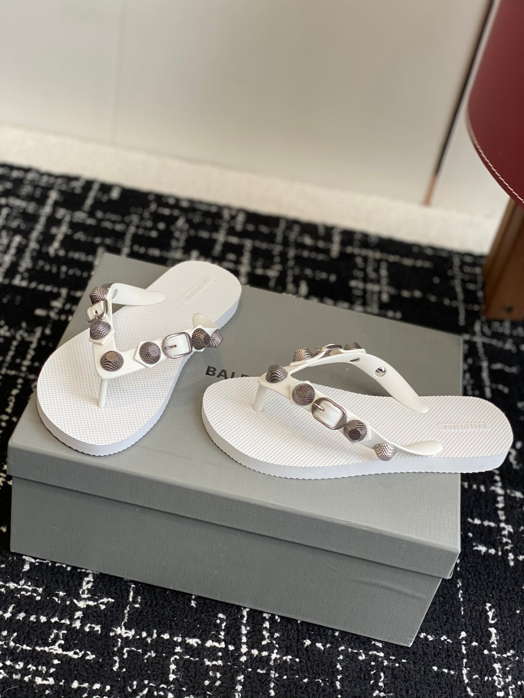 White Balenciaga thong sandals with metallic buckle and studded straps