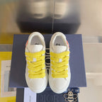 Unisex white sneakers with bright yellow laces, rear view on blue box
