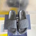 Dior slide sandals, front view with two dark gray slides and jacquard logo bands