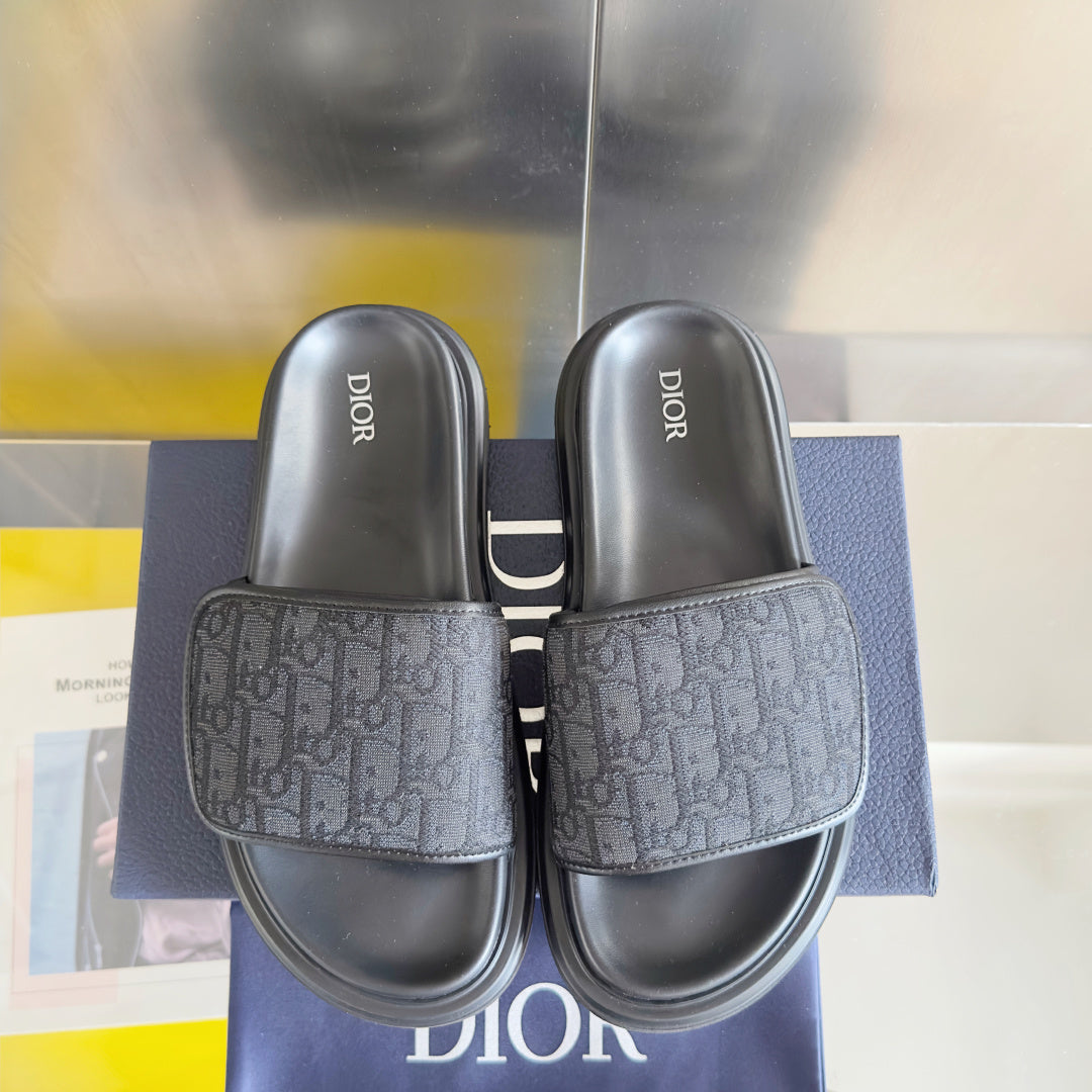 Dior slide sandals, front view with two dark gray slides and jacquard logo bands