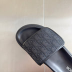 Dior slide sandal, single close-up with jacquard logo strap on dark gray footbed