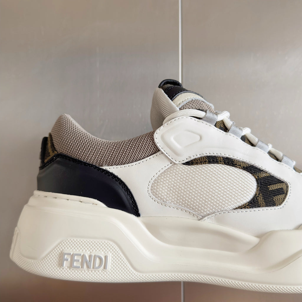 Fendi unisex sneakers close-up, white textured upper with black side panel and logo