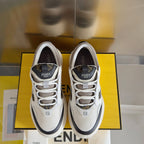 Fendi unisex sneakers shown front-on, white uppers with black trim and lace-up closure