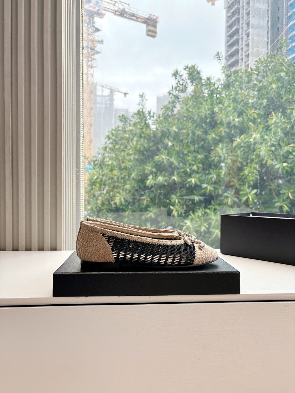 Chanel beige woven ballet flat with black knit side stripe and braided bow on box