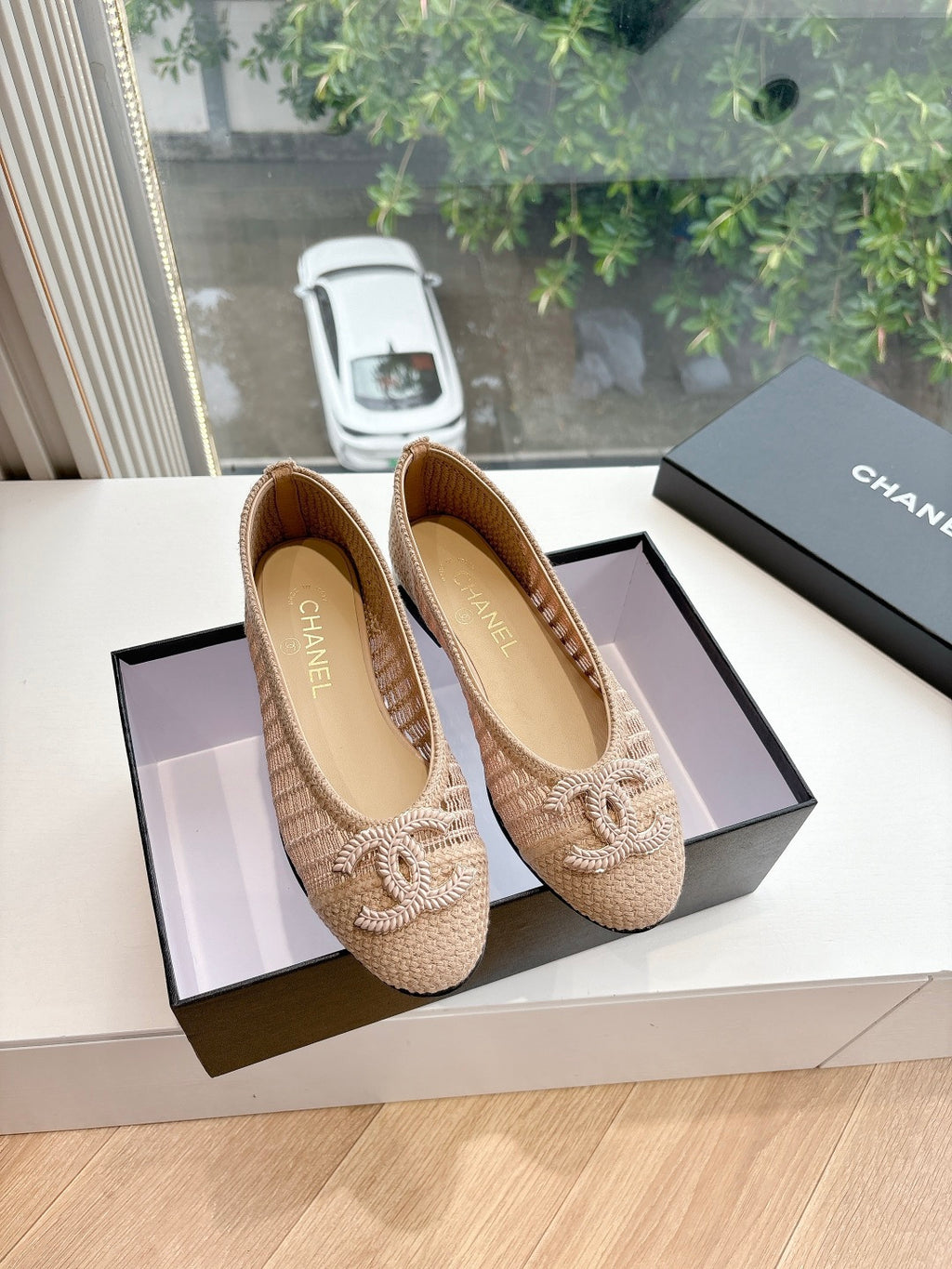 Beige woven ballet flats with braided bow detail and CHANEL logo on upper, pair.