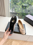 Beige woven ballet flat on box with braided bow detail, side angle.