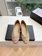 Beige woven ballet flats with braided bow detail and CHANEL logo on lining, pair front.