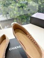 Beige woven ballet flats with CHANEL logo on insole, close-up of interior.