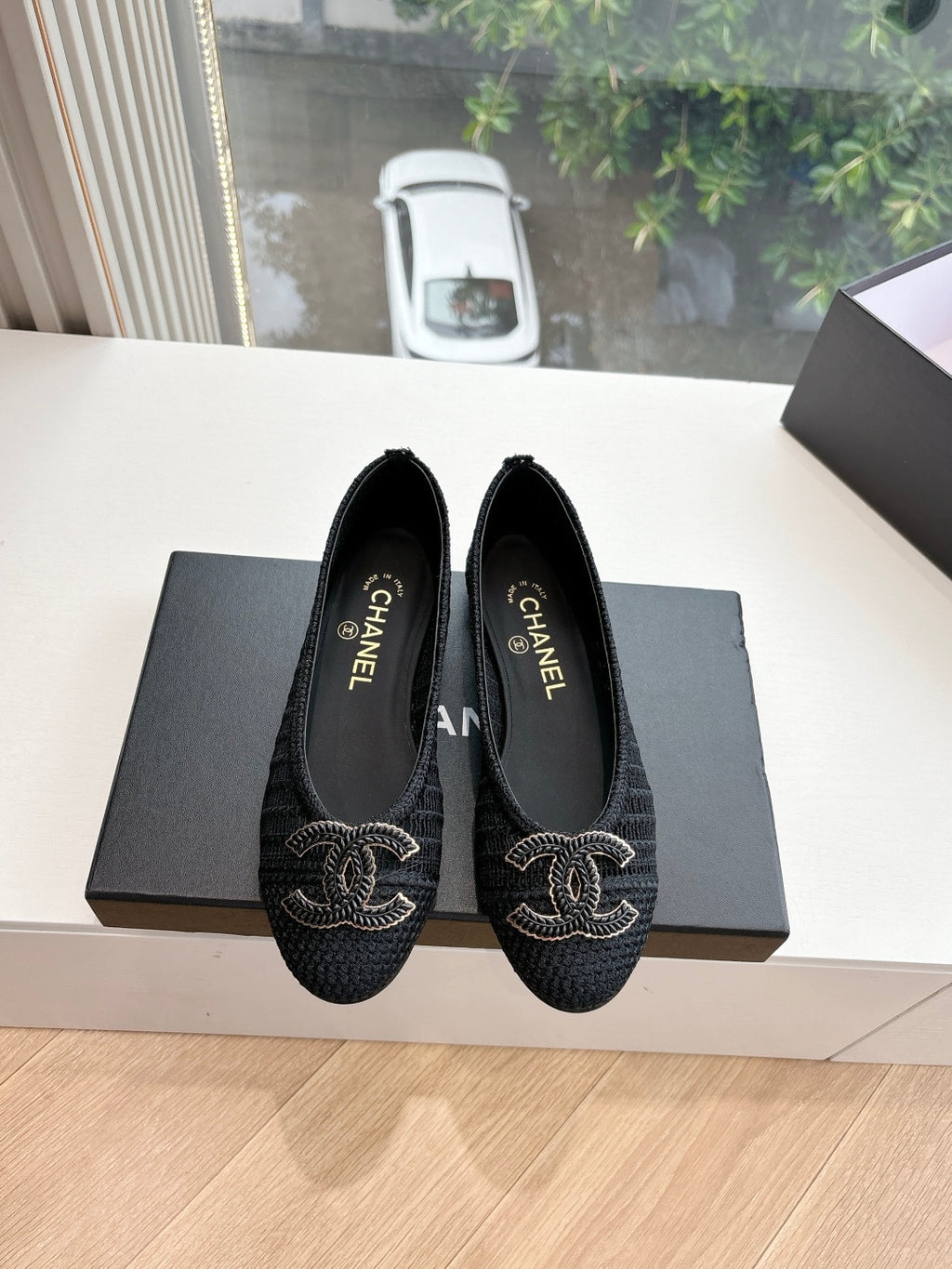 Pair of black Chanel knit slip-on flats with CC logo embroidery on toes