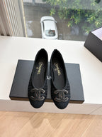Pair of black Chanel knit slip-on flats with CC logo embroidery on toes