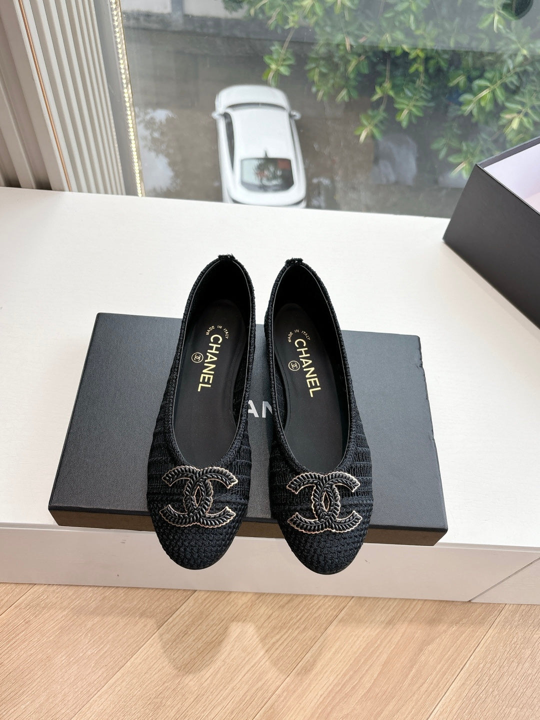 Pair of black Chanel knit slip-on flats with CC logo embroidery on toes