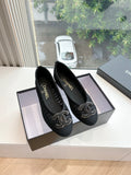 Black Chanel knit slip-on flats with CC-style logo embroidery on toes