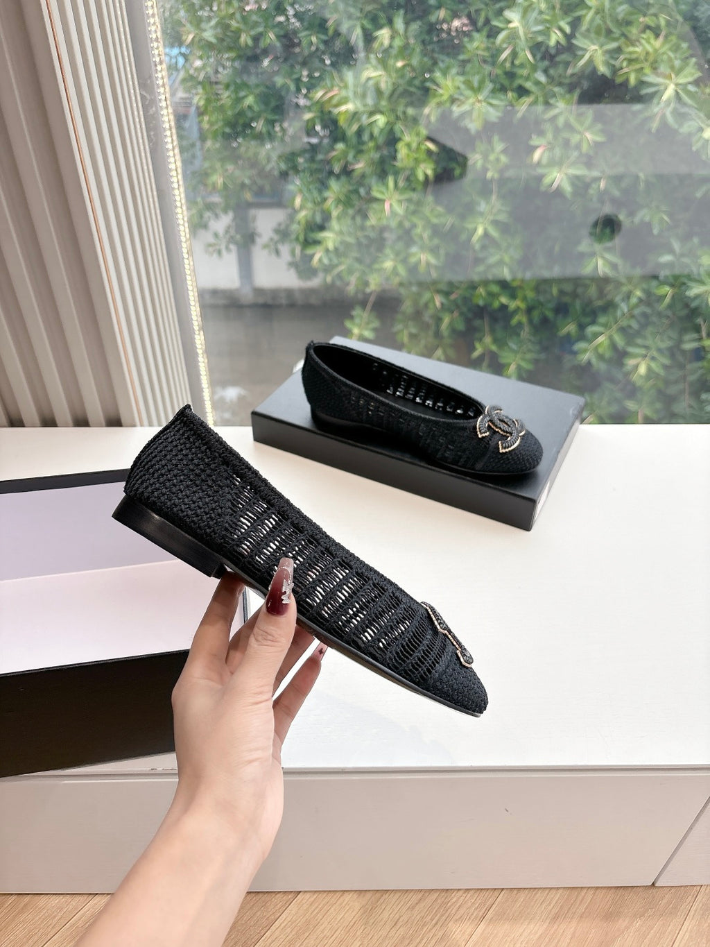 Black Chanel knit slip-on flats with CC logo detail on top
