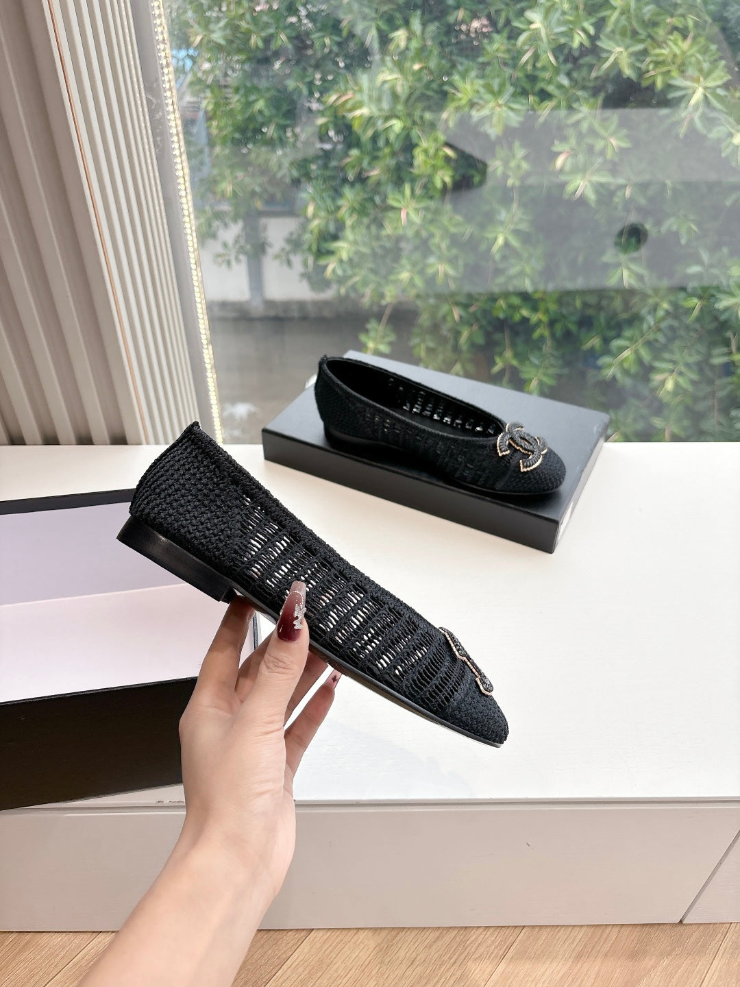 Black Chanel knit slip-on flats with CC logo detail on top
