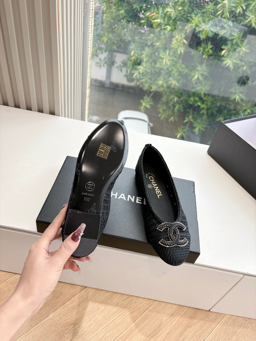 Black Chanel knit slip-on flats with embroidered CC logo; inside view showing lining