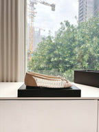 Chanel ladies beige woven ballet flat on a black shoebox
