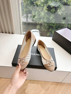 Chanel ladies beige woven ballet flats held in hand, with bow detail
