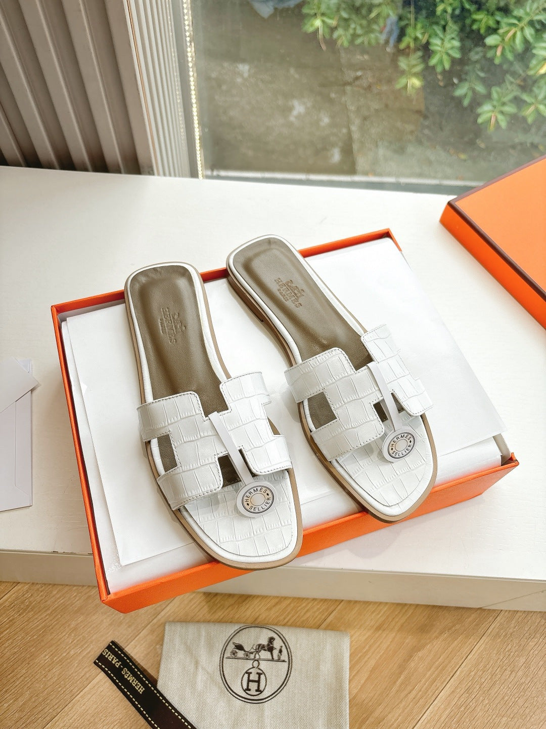 Hermes ladies' slide sandals in white with double straps and round logo detail