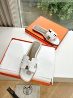 Hermes ladies' slide sandals with white double-strap design and round logo emblem