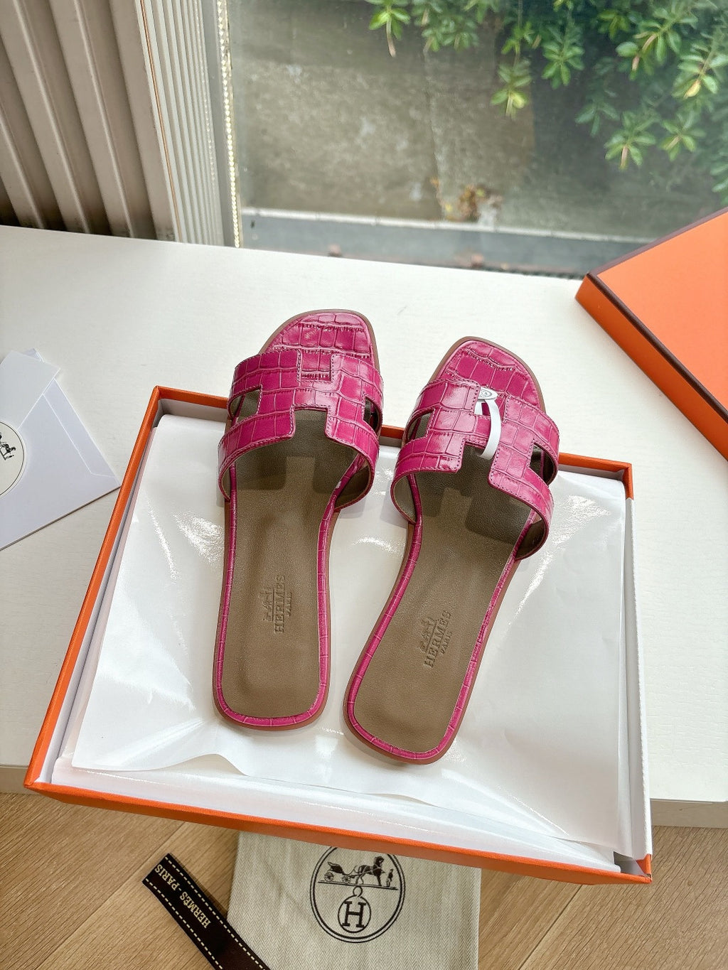 Hermes pink croc-pattern slide sandals, back view with heel strap