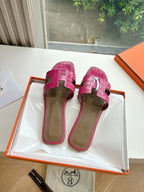 Hermes pink croc-pattern slide sandals, back view with heel strap
