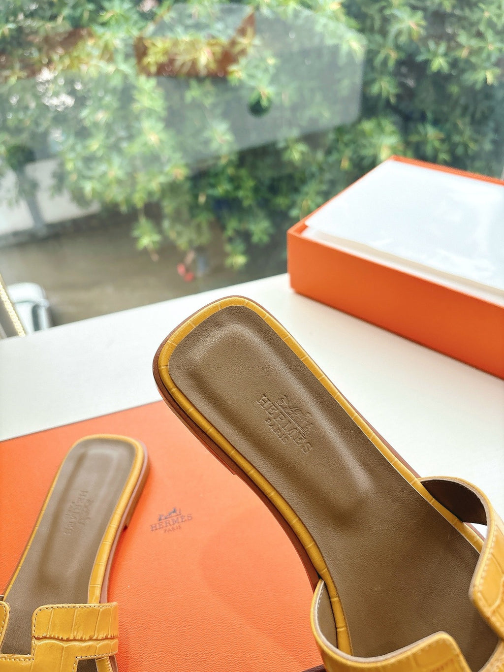 Women’s yellow croc-embossed slide sandal with open toe and molded footbed profile