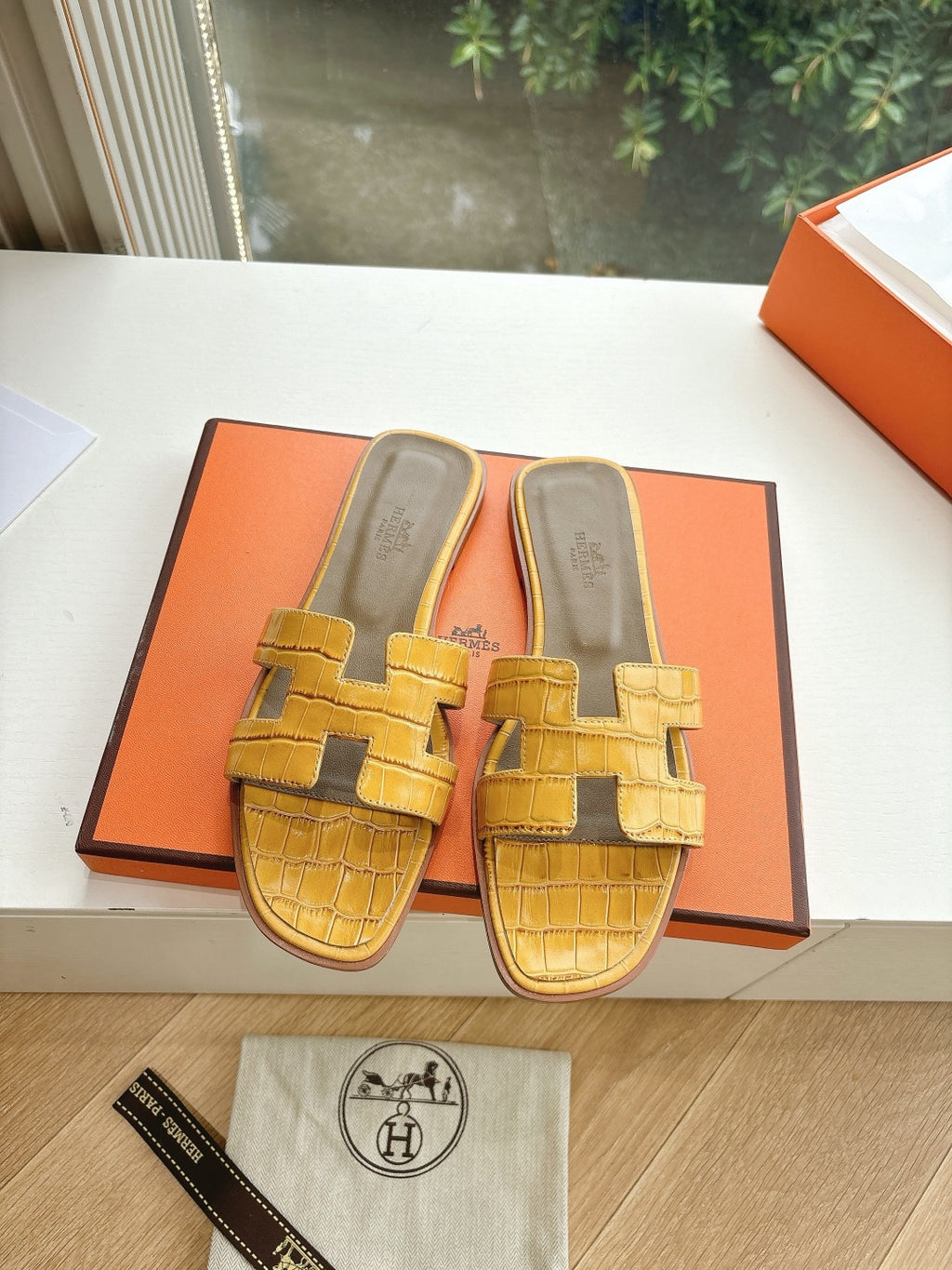 Women’s yellow croc-embossed slide sandals with square buckle straps and cushioned sole