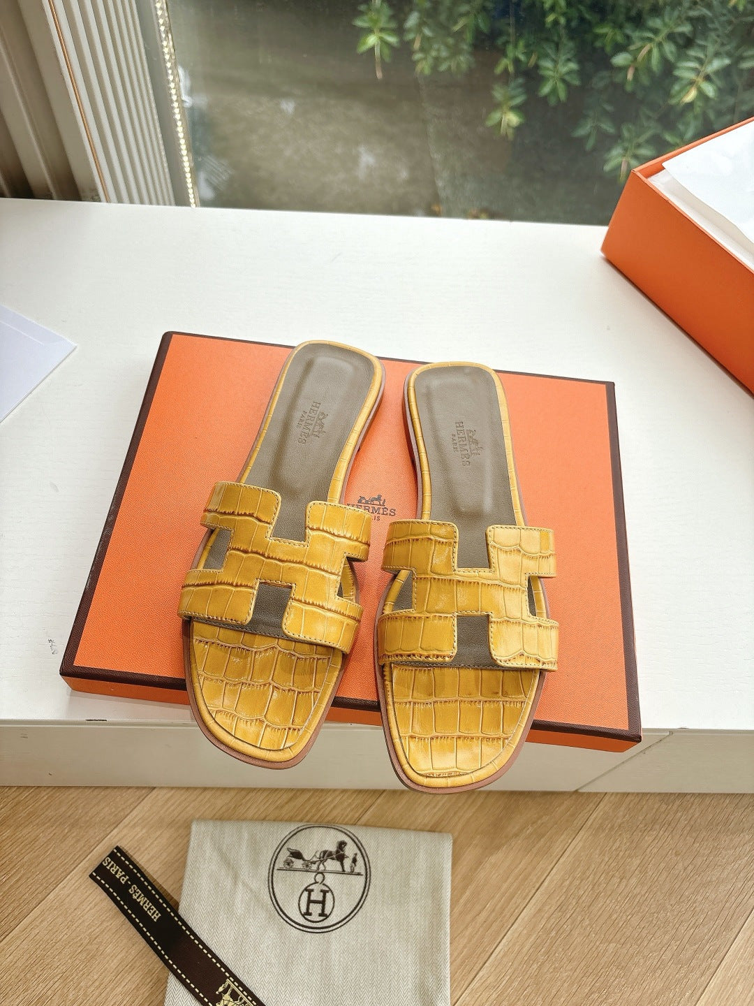 Women’s yellow croc-embossed slide sandals with square buckle straps and cushioned sole