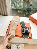 Hermes slide sandals black with white H-style straps, with sole tag and shoebox.