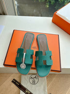 Hermes ladies sandals, teal green open-slide with H ornament and logo footbed