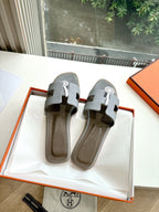Hermes slide sandals, light gray textured leather, open-toe with H buckle
