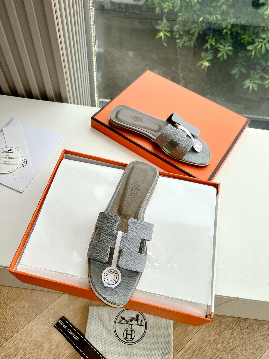 Hermes slide sandals in light gray textured leather with H logo buckle