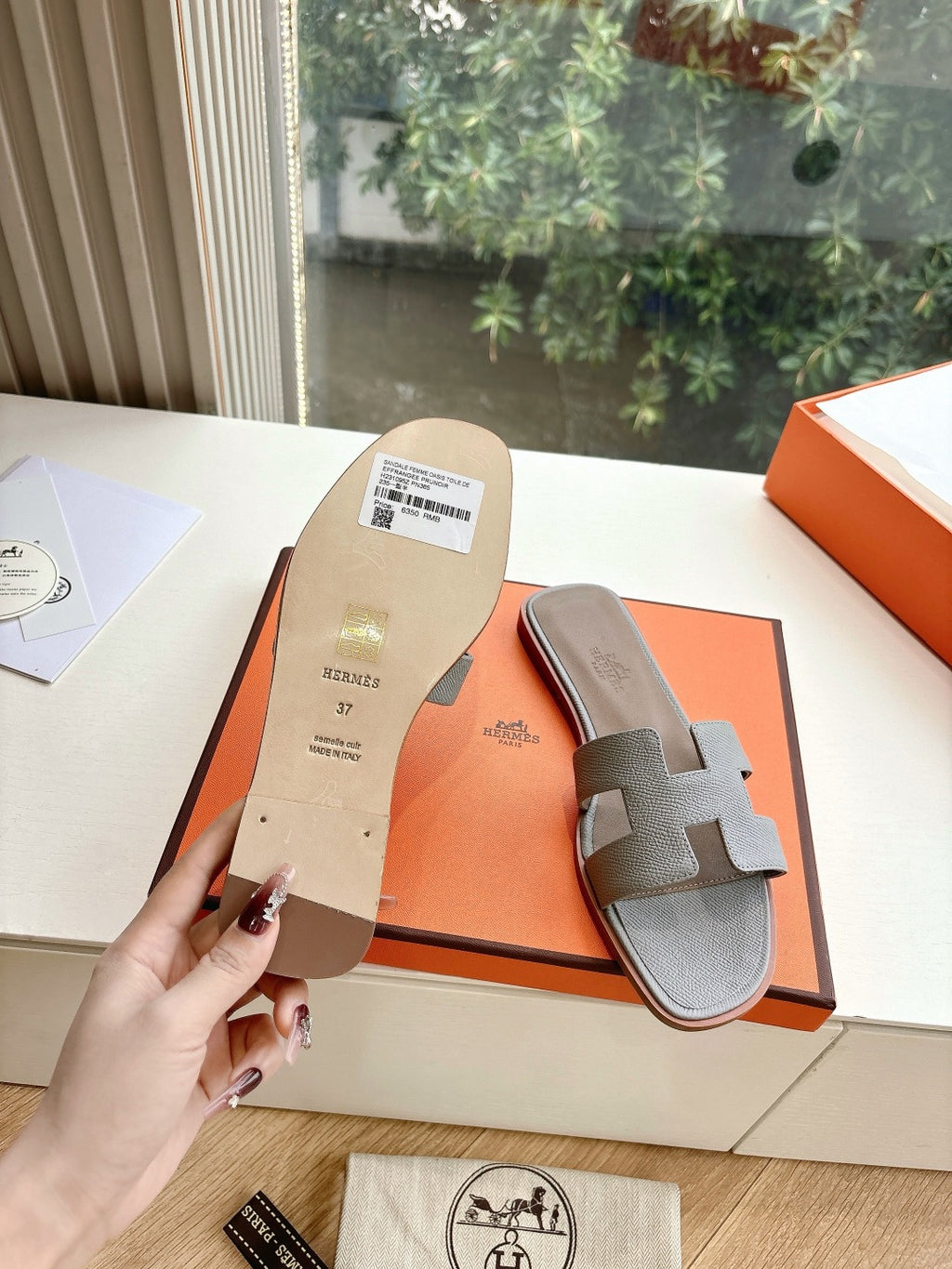 Hermes slide sandals heel and outsole view with printed size label on box insert