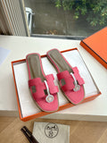 Hermes pink leather slide sandals with adjustable strap and circular emblem buckle