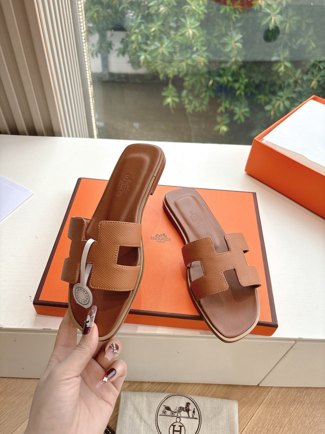 Hermes tan slide sandals with geometric straps and smooth leather footbed