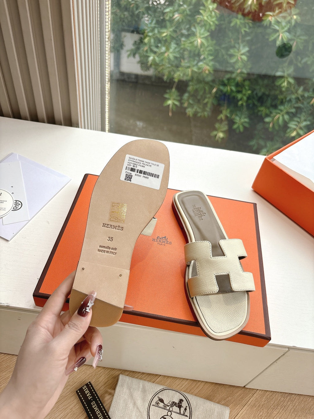 Hermes slide sandals in light beige with two straps and embossed sole branding
