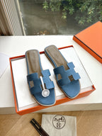 Blue Hermes slide sandals with H cutout, cushioned footbed, in presentation box