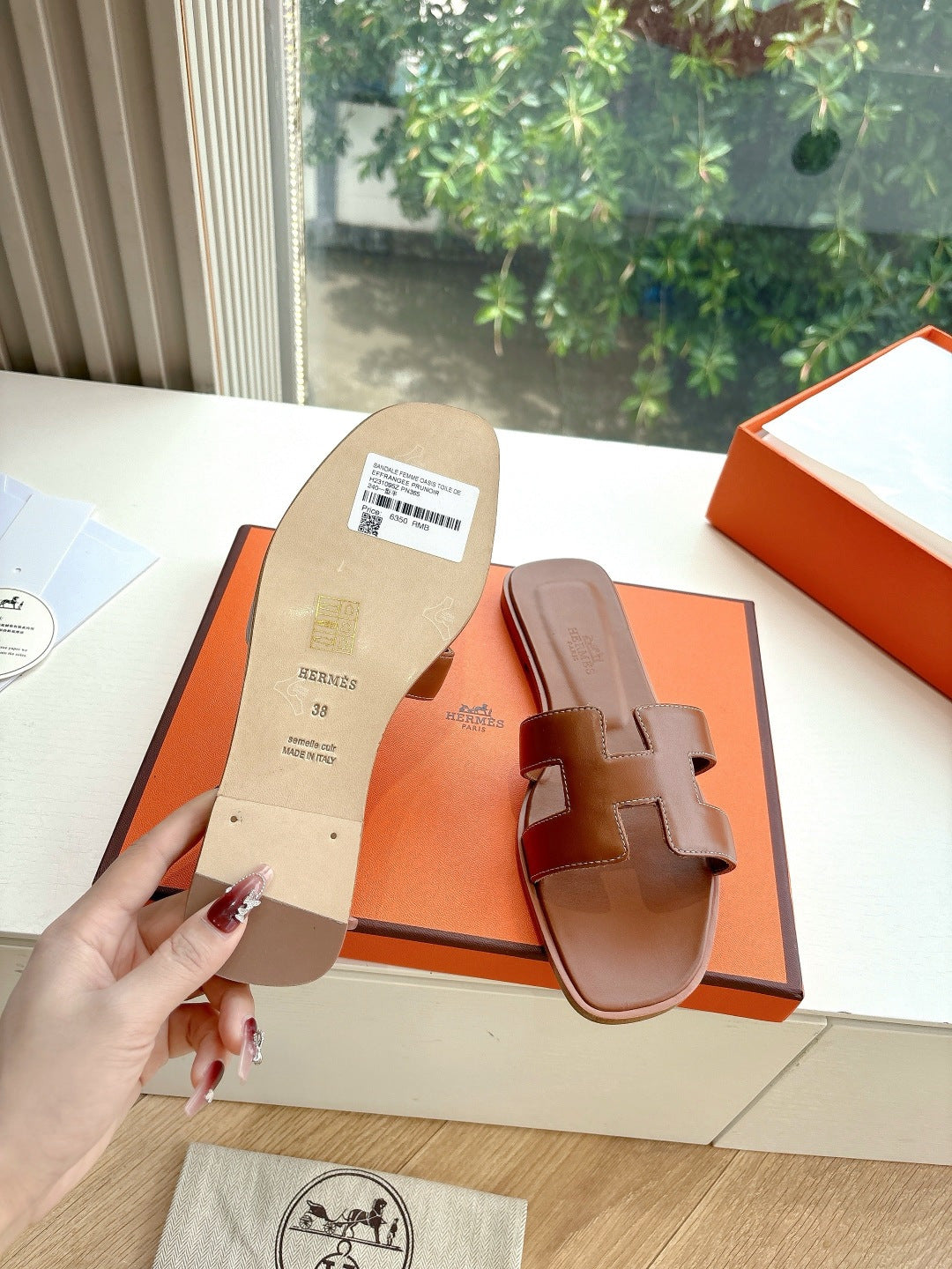 Hermes women's brown leather slide sandals, sole and strap side view