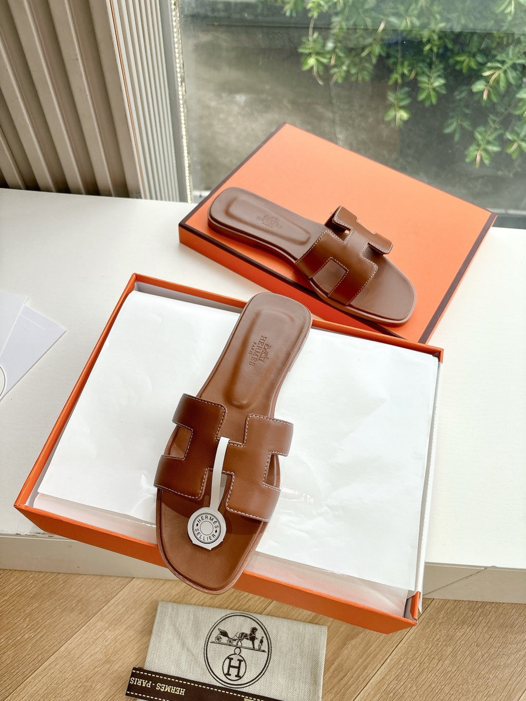 Hermes women's brown leather slide sandals, open toe, logo strap detail