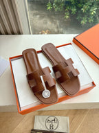 Hermes women's brown leather slide sandals, two wide straps, logo emblem