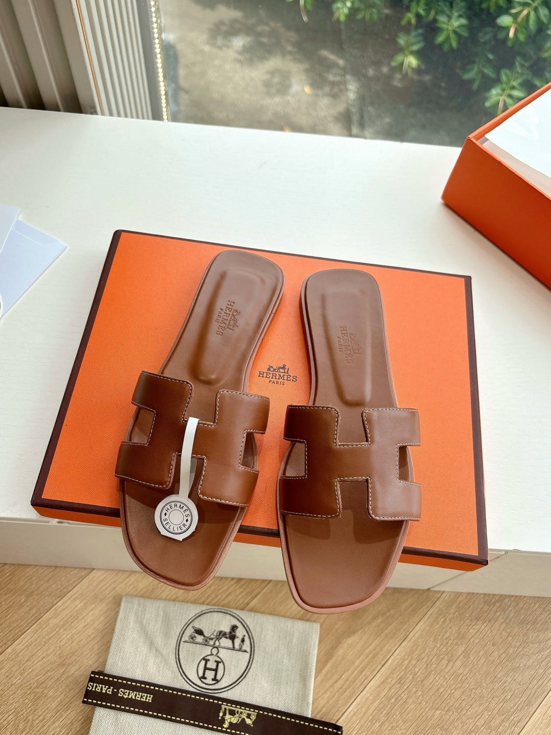 Hermes women's brown leather slide sandals with toe bridge, stacked straps