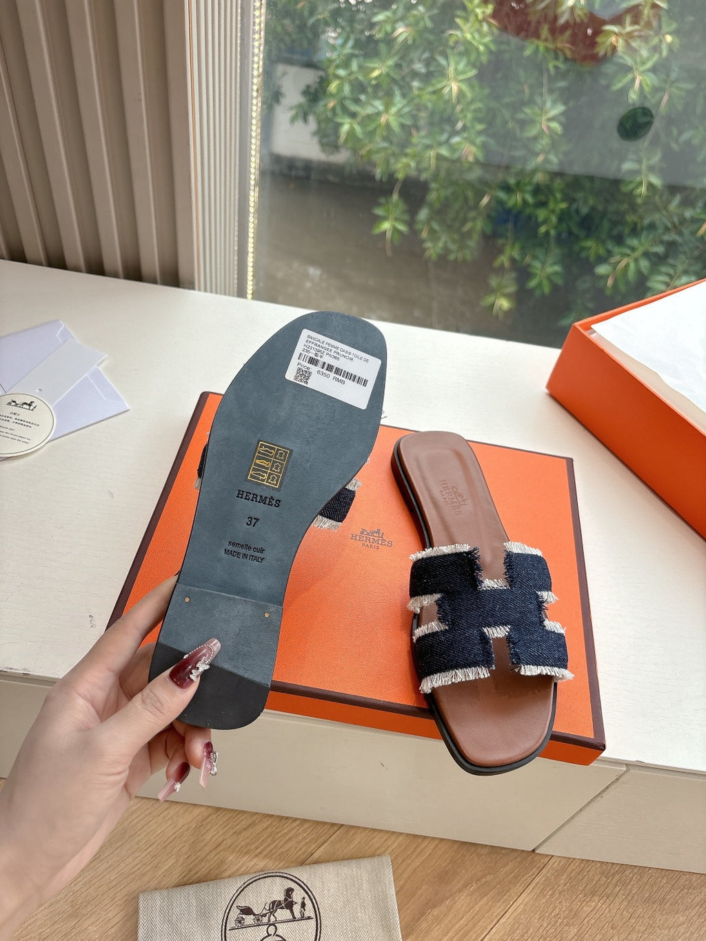 Hermes slide sandal outsole view, brown leather sandal with navy-and-light-blue fabric upper