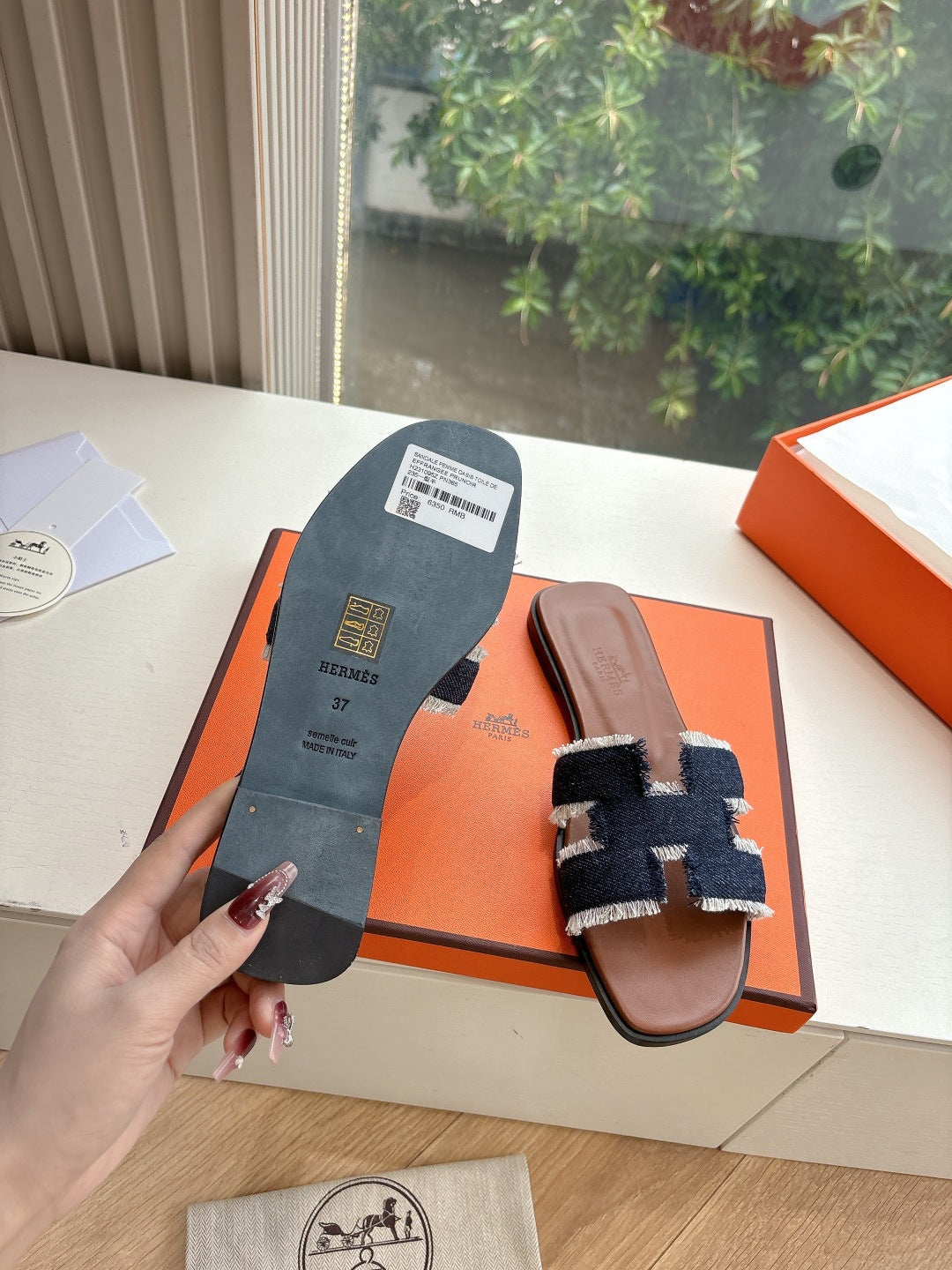 Hermes slide sandal outsole view, brown leather sandal with navy-and-light-blue fabric upper