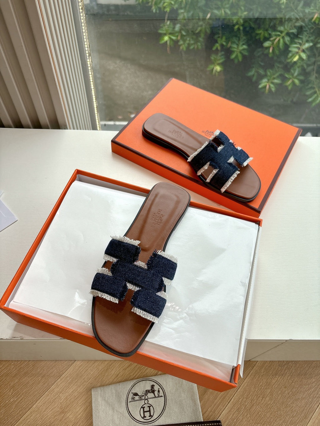 Pair of Hermes slide sandals, brown leather soles with dark navy and light blue textured straps