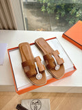 Hermes women's tan slide sandals with double straps and round logo medallion