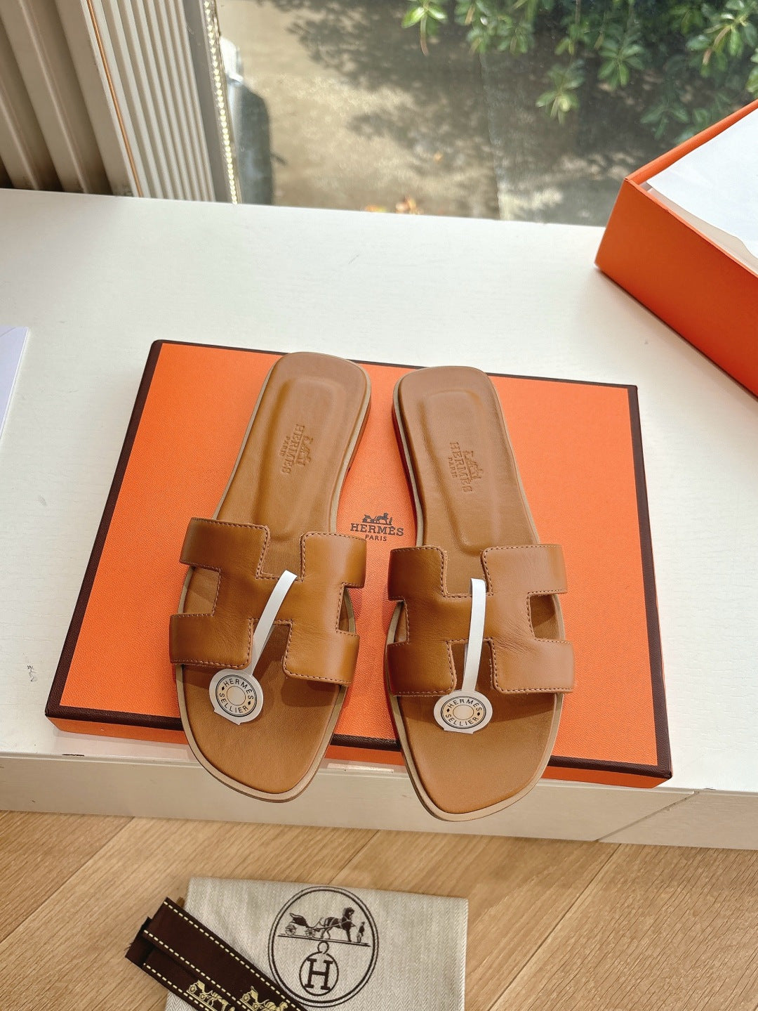 Hermes women's tan slide sandals, open toe double straps with silver-tone round logo medallion
