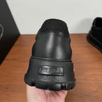 Black sneaker heel with PRADA logo on textured rubber sole and padded back