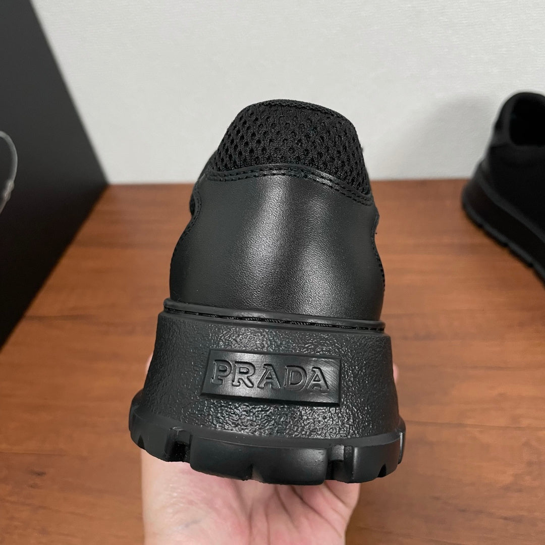 Black sneaker heel with PRADA logo on textured rubber sole and padded back