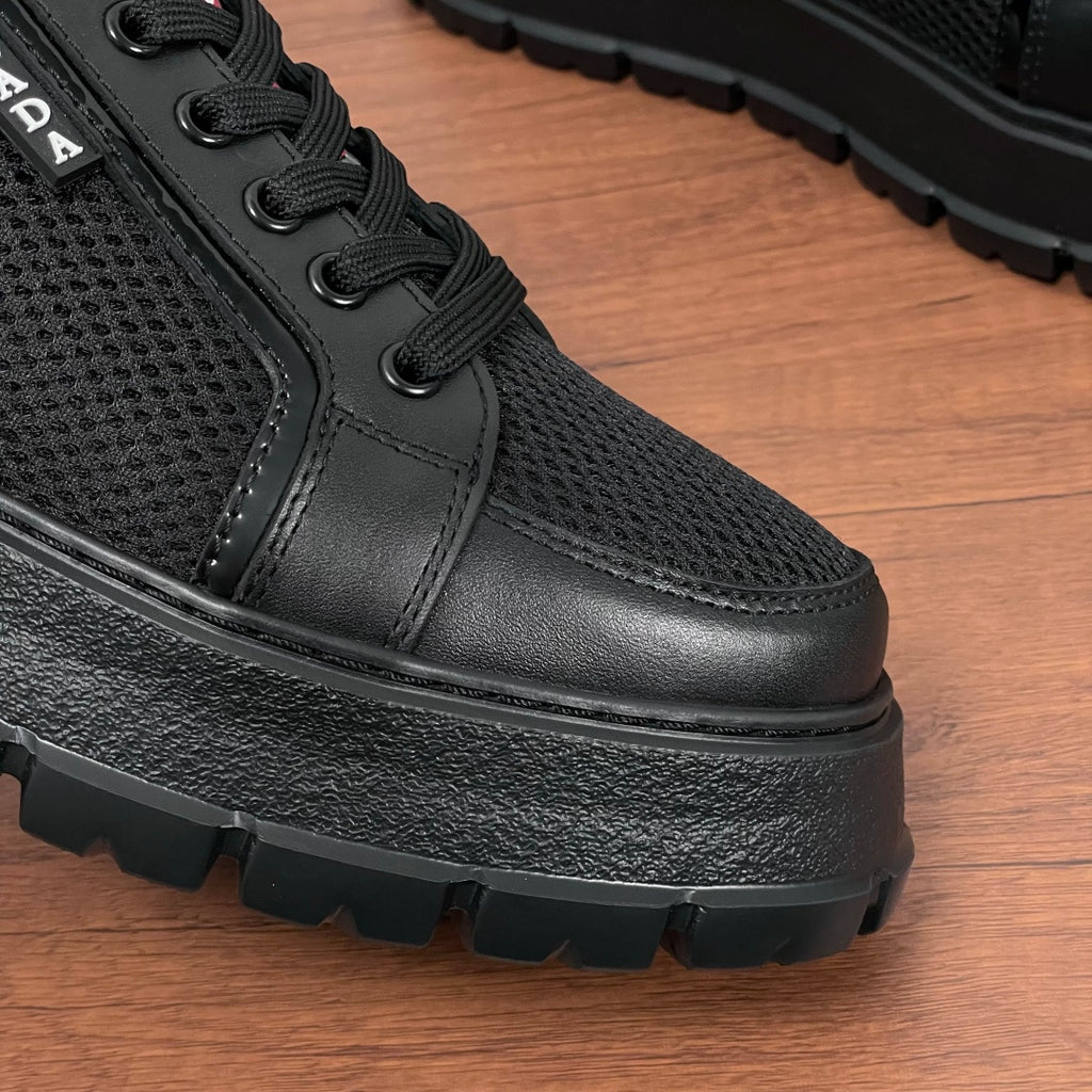 Black chunky-soled lace-up sneaker front quarter with textured leather toe